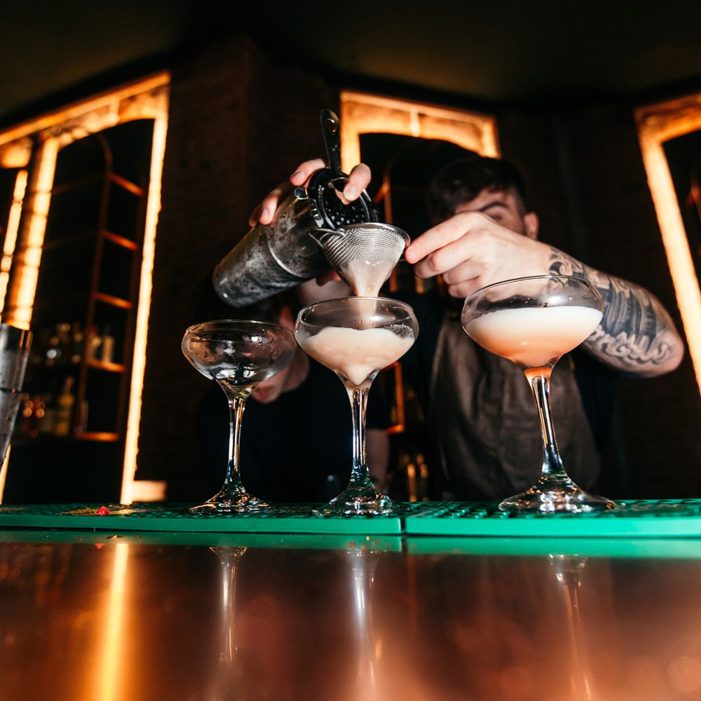 A bartender preparing cocktails at one of the Haymarket venues